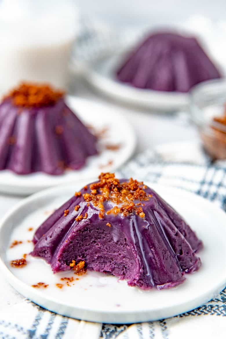 Ube halaya on a plate, with a piece spooned off to show the creamy texture inside