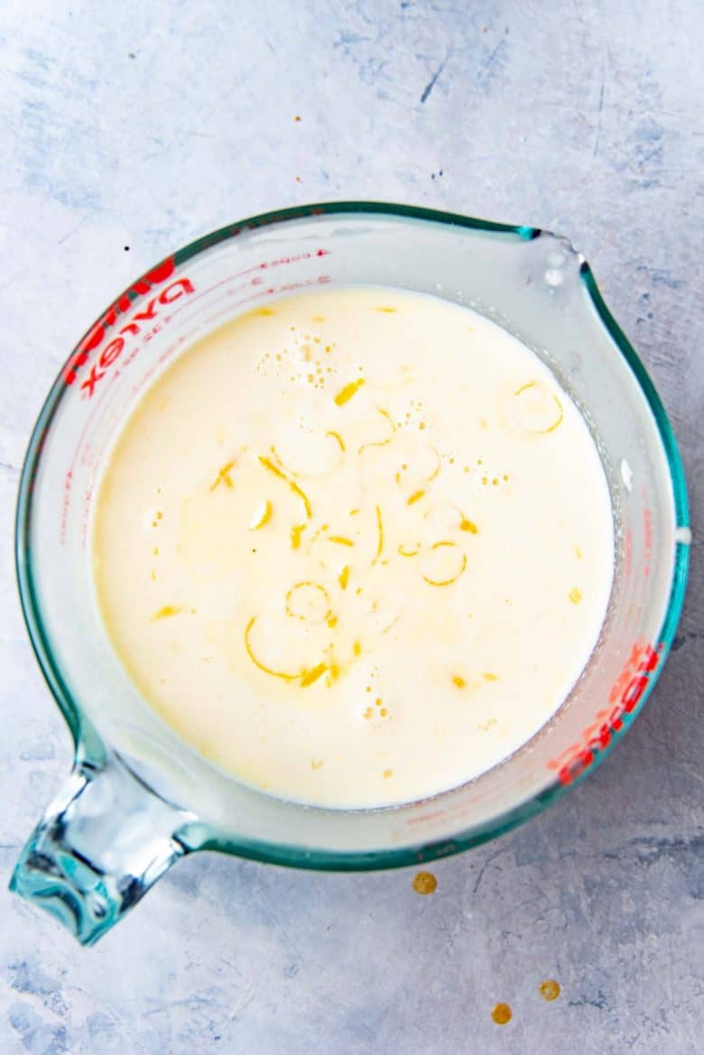 The custard base in a large jug with lemon zest
