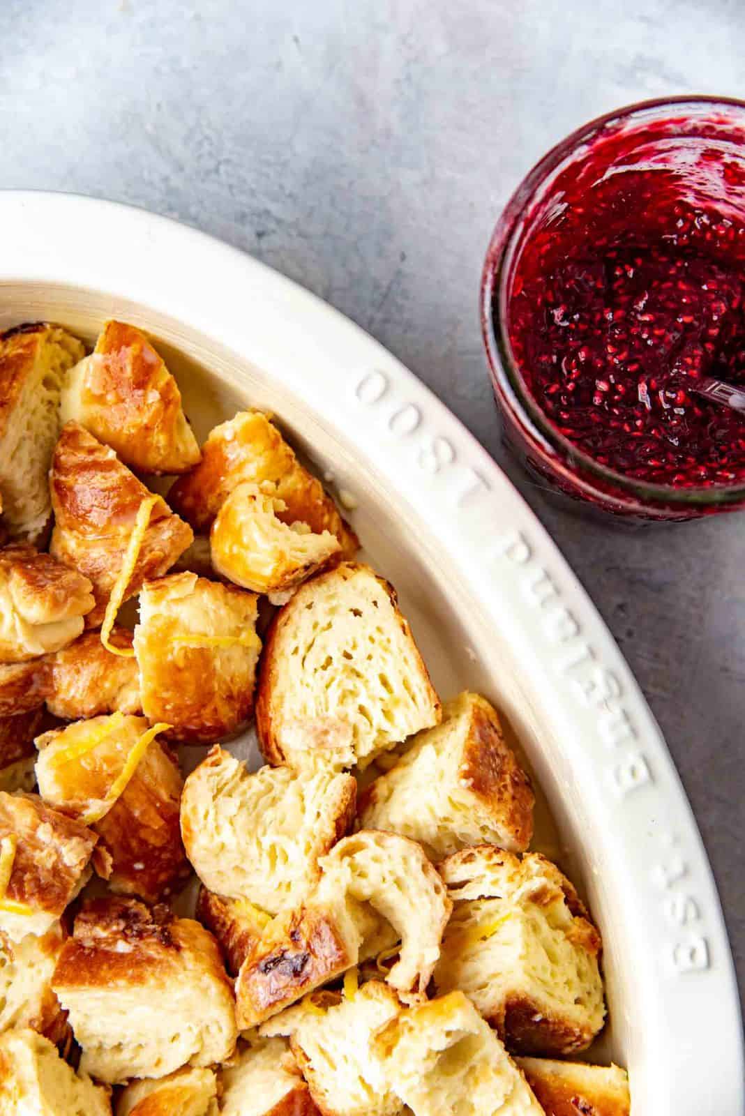 Half of the croissant pieces in the buttered dish.