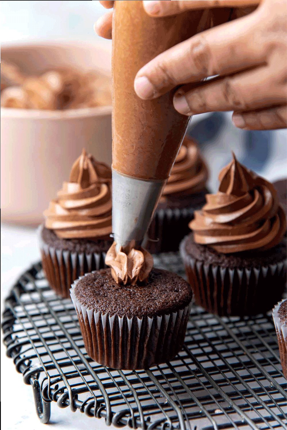 Frosting the chocolate cupcakes
