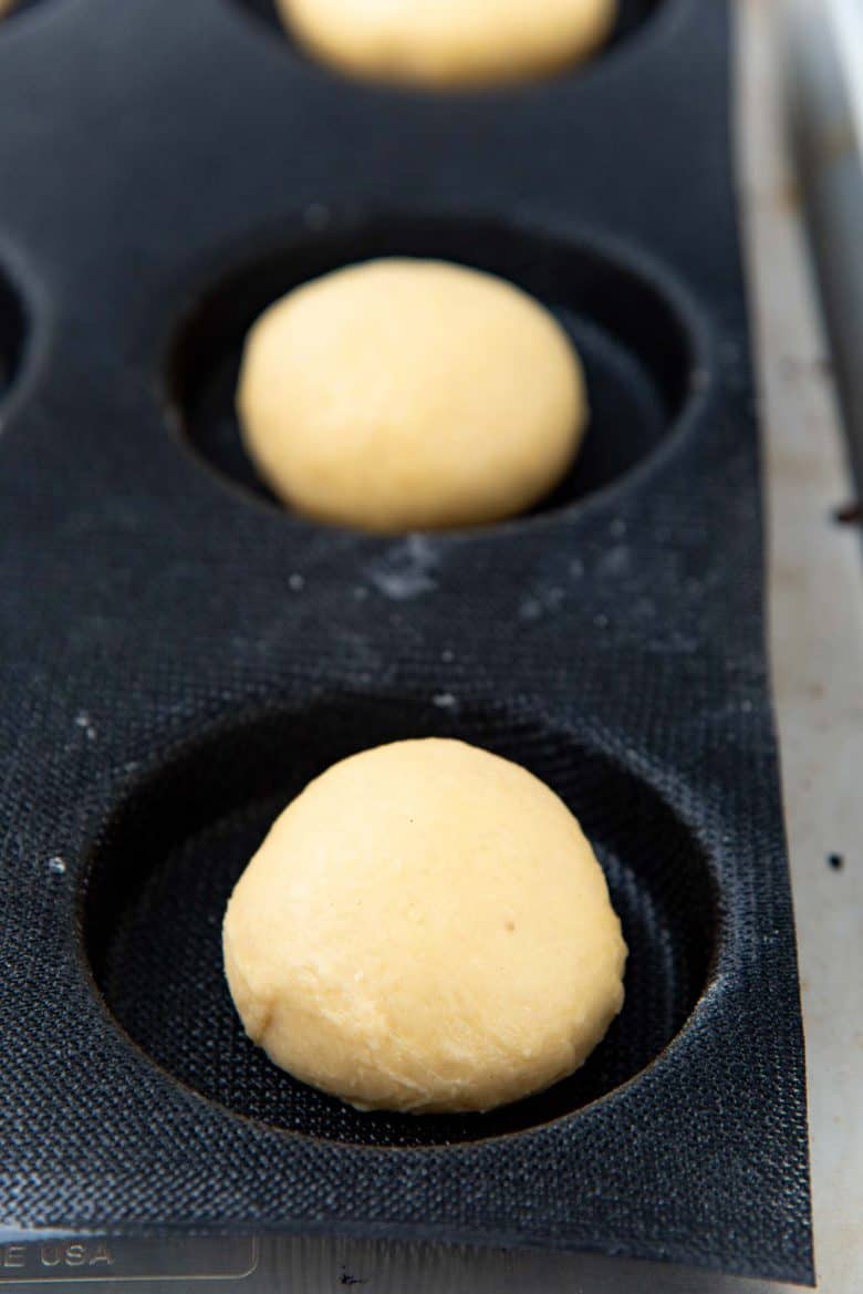 Brioche bun dough in a silicone burger mold