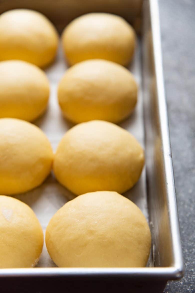Slider buns before baking in a baking pan