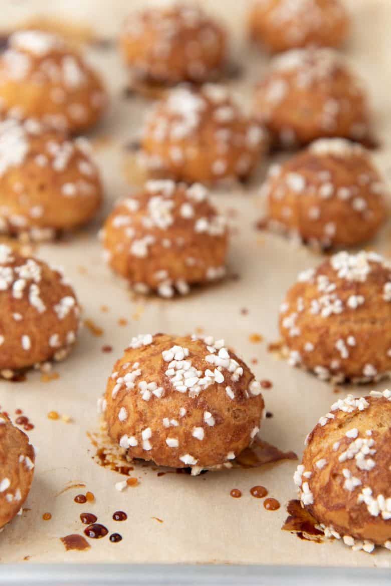 Freshly baked chouquettes on the baking tray