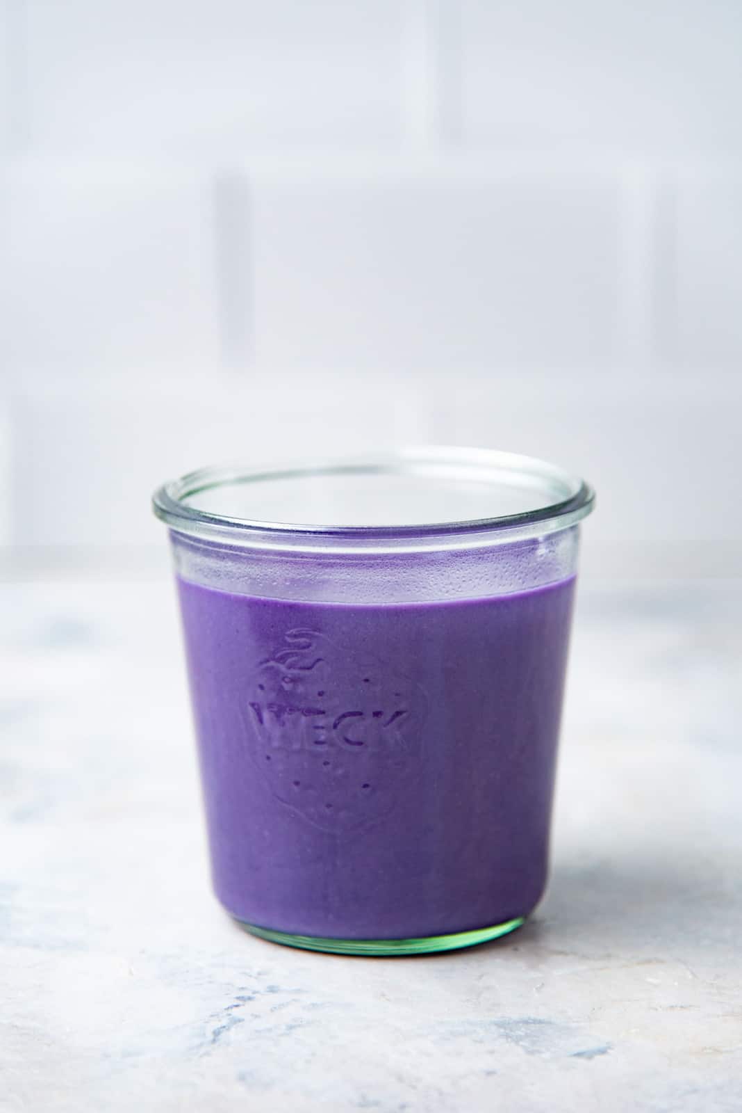 The ube base mixed with milk and placed in a glass jar for storage