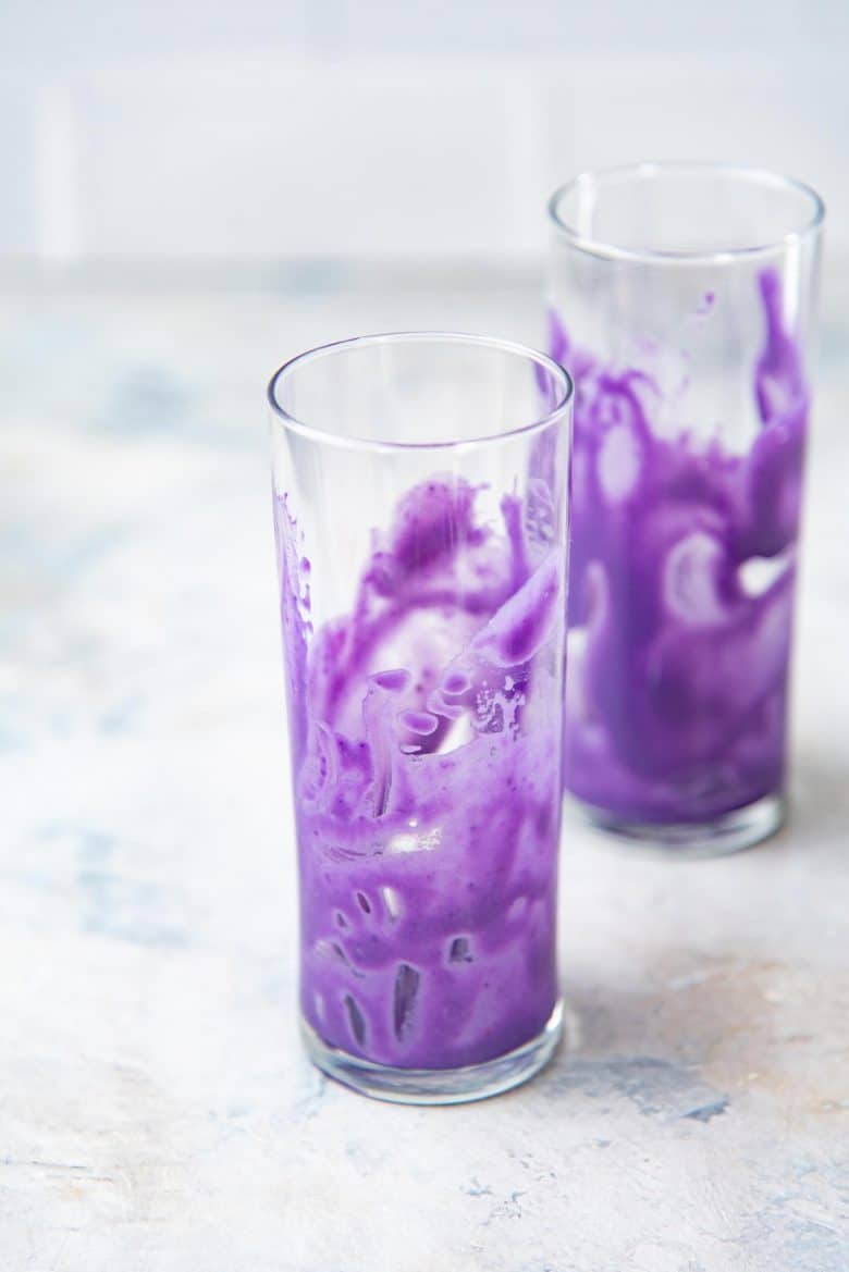 A serving glass smeared with the ube halaya base to create purple streaks on the inside