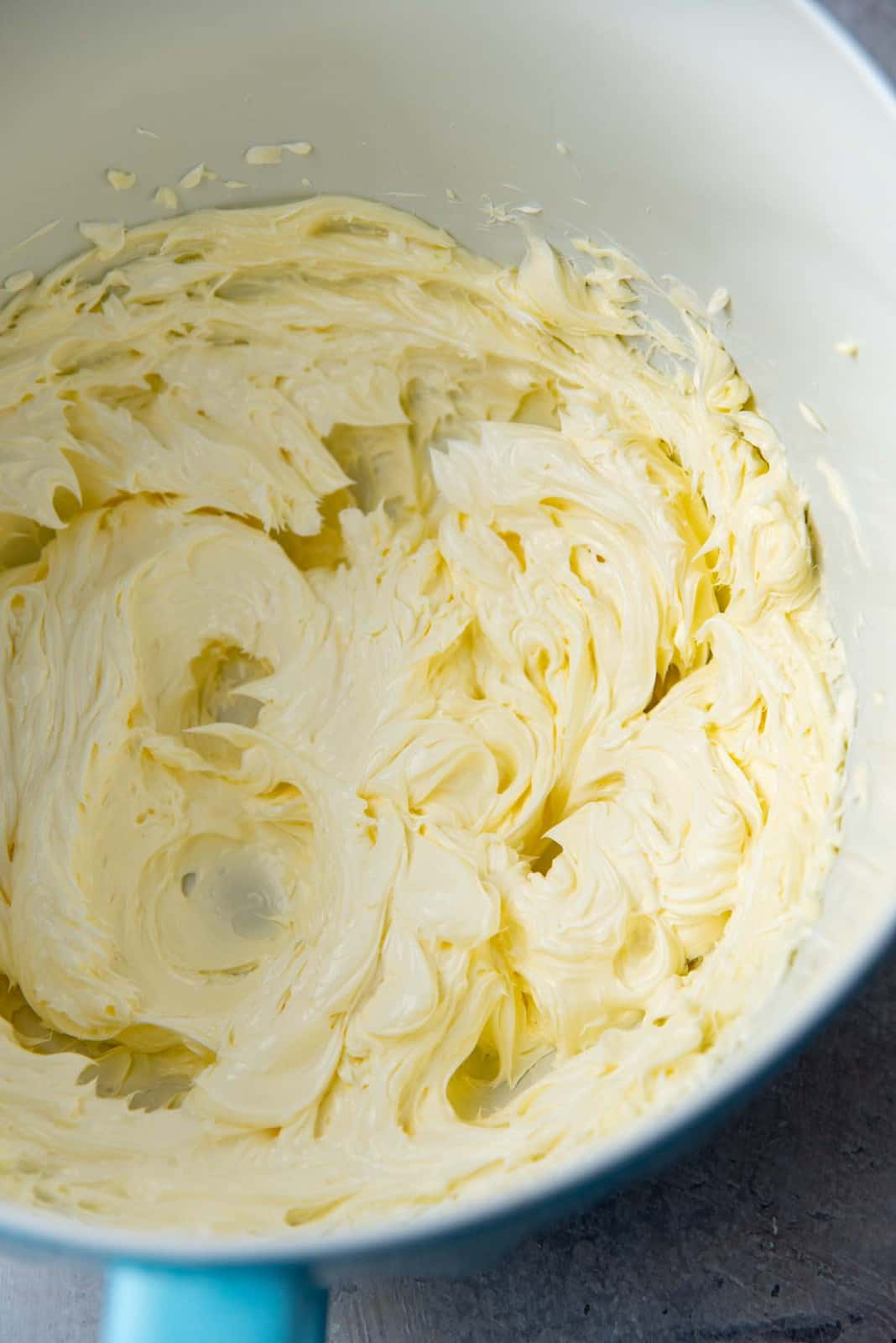 Fluffy, creamy butter in a mixer bowl after being mixed with a hand mixer
