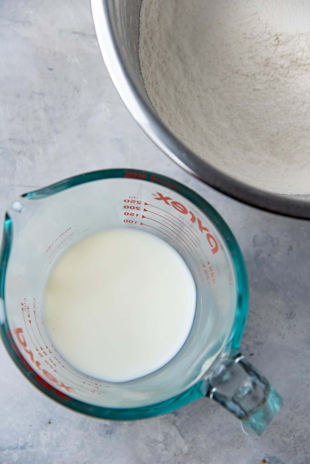 room temperature milk in a jug next to the bowl of dry ingredients