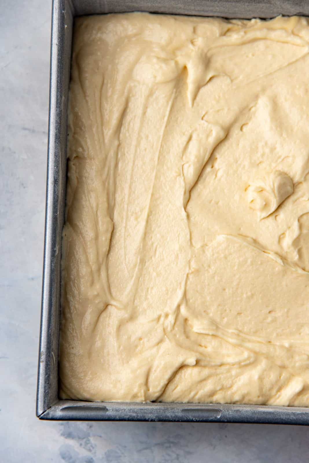 The butter cake batter in the cake pan, ready to be baked