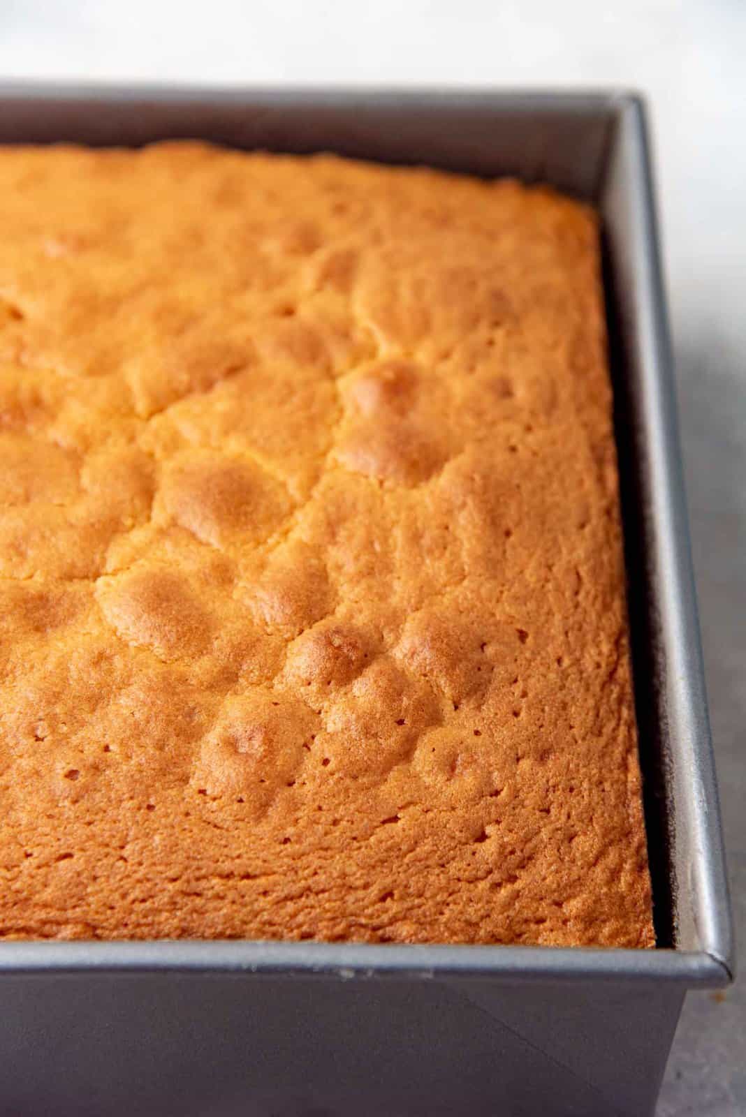 A freshly baked sri lankan butter cake, still in the cake pan