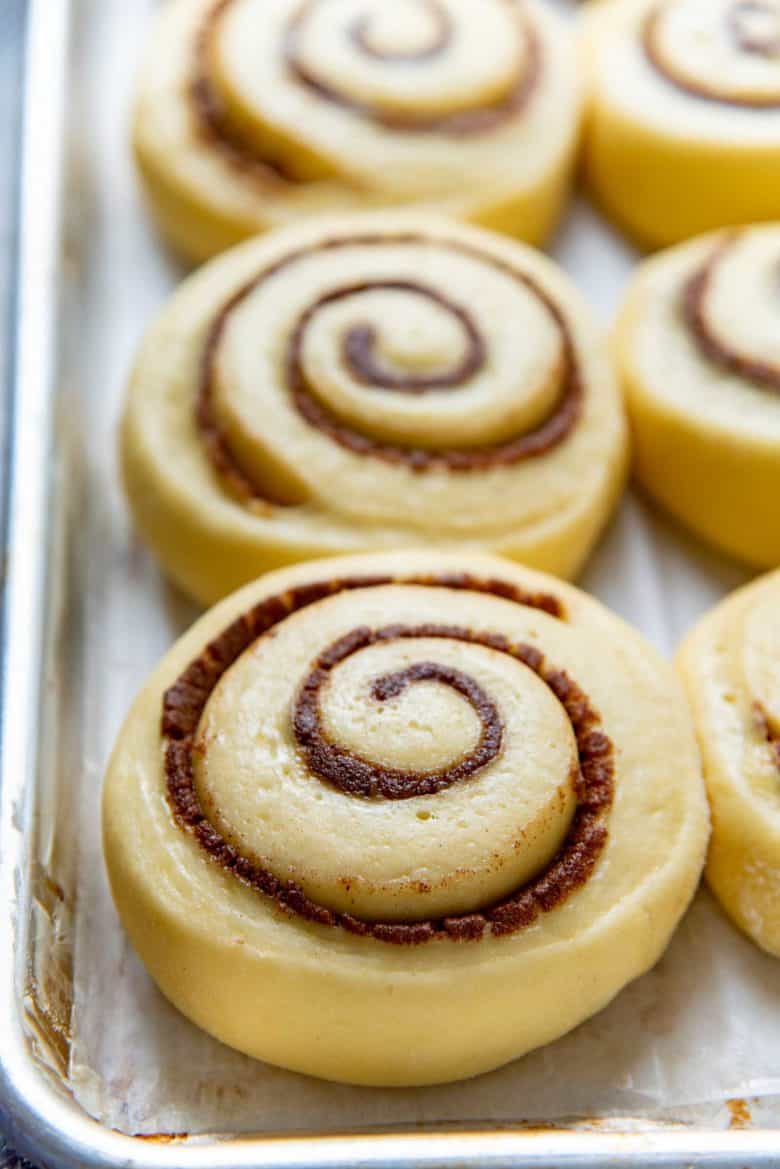 A close up of the proofed cinnamon rolls