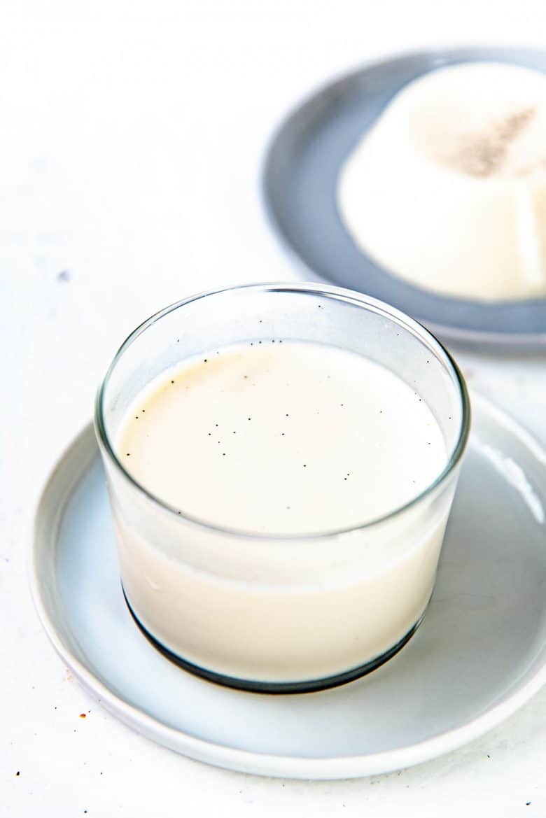 Panna cotta set inside a glass with vanilla seed flecks