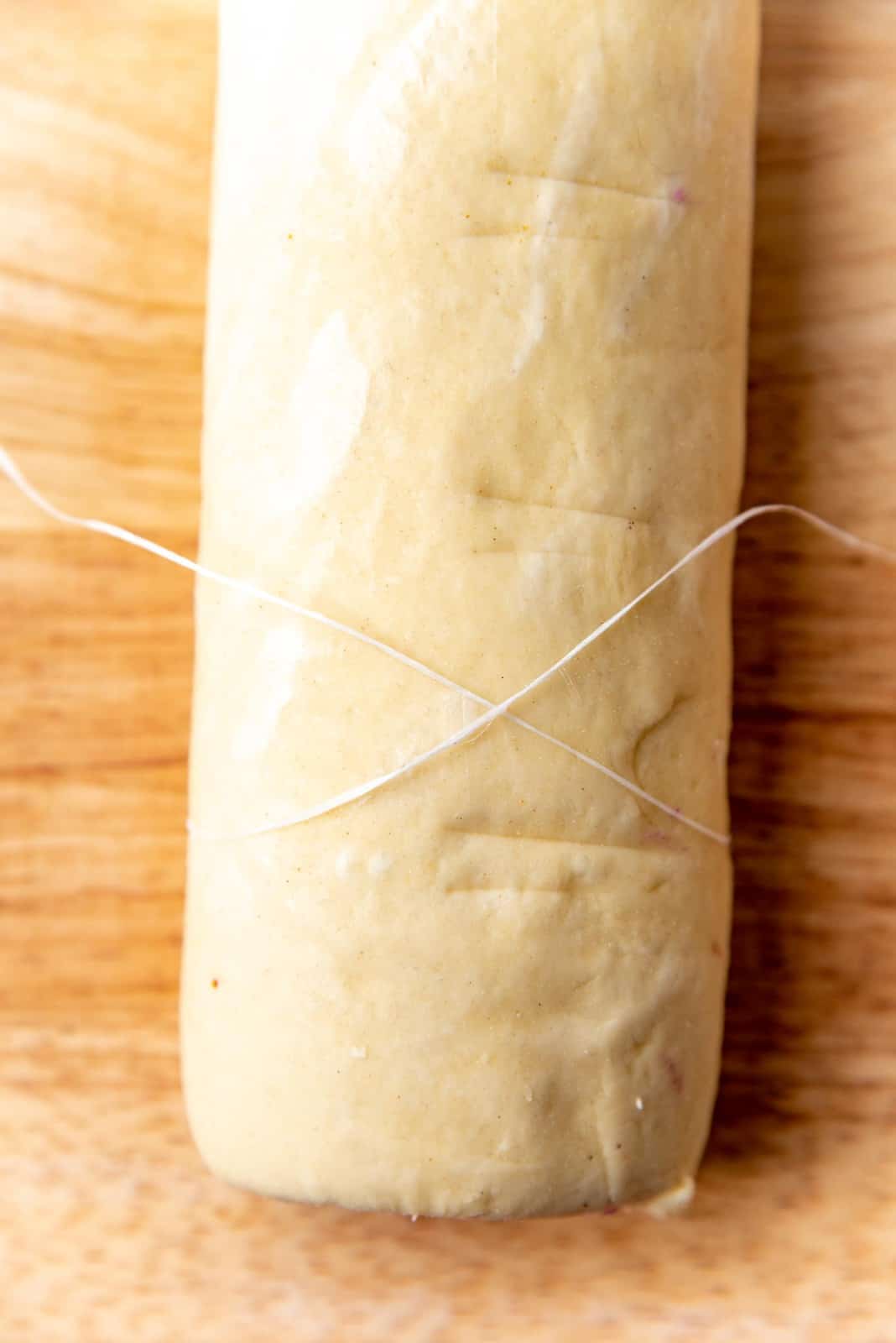 Cutting the dough tube with a unflavored dental floss wrapped around it