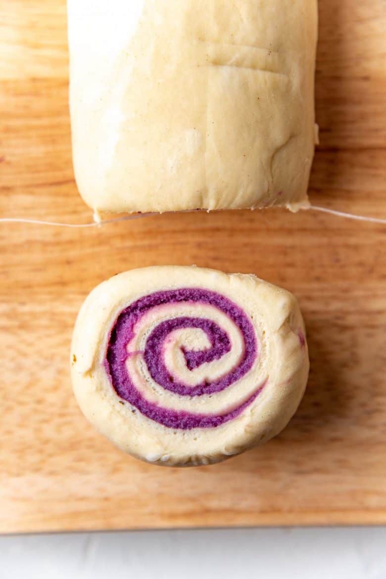 A portion of the ube bread roll, showing the ube swirl.