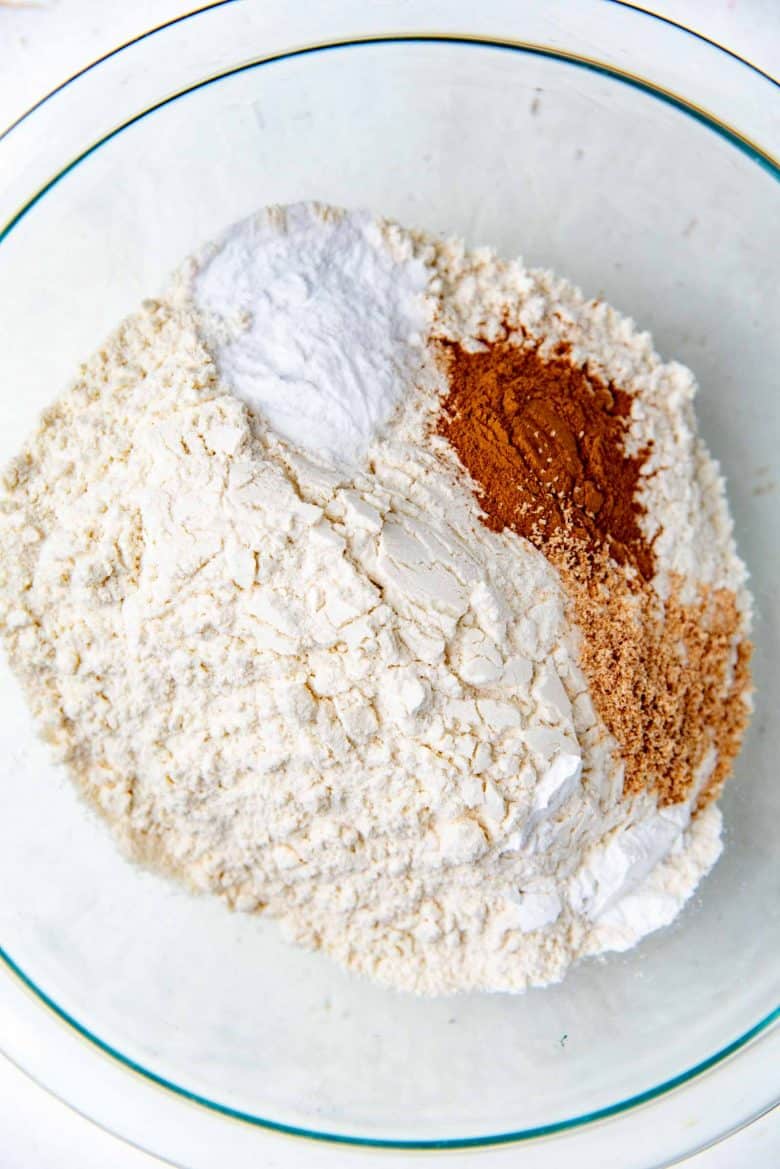 Flour, baking powder and soda, cinnamon and nutmeg in a bowl