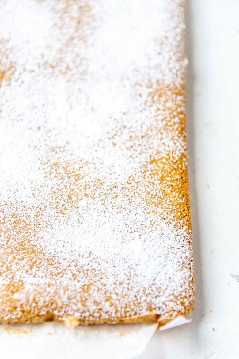 Confectioners sugar sifted over the surface of the pumpkin cake