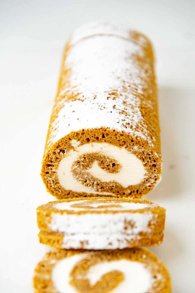 Angled view of sliced pumpkin roll cake