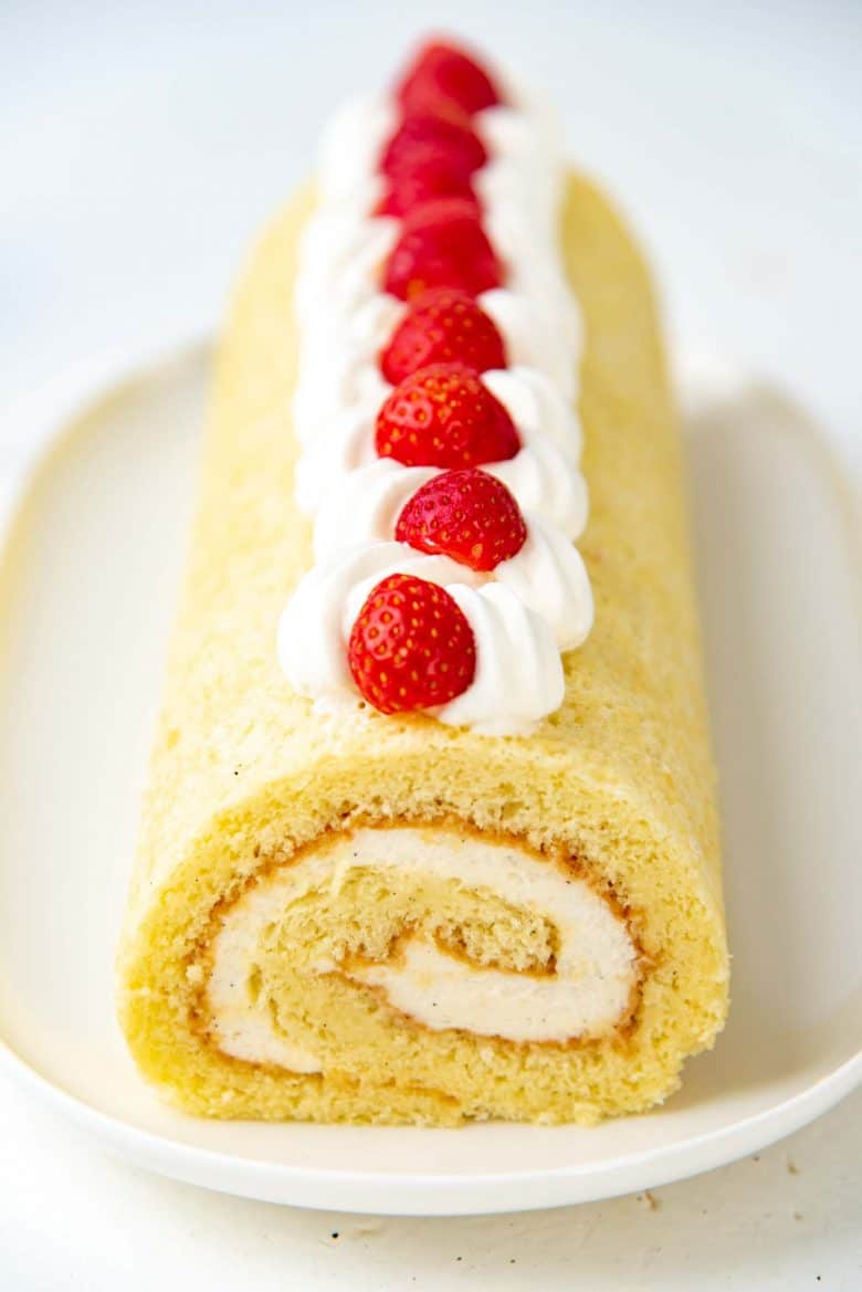A close up of the vanilla swiss roll on a serving tray