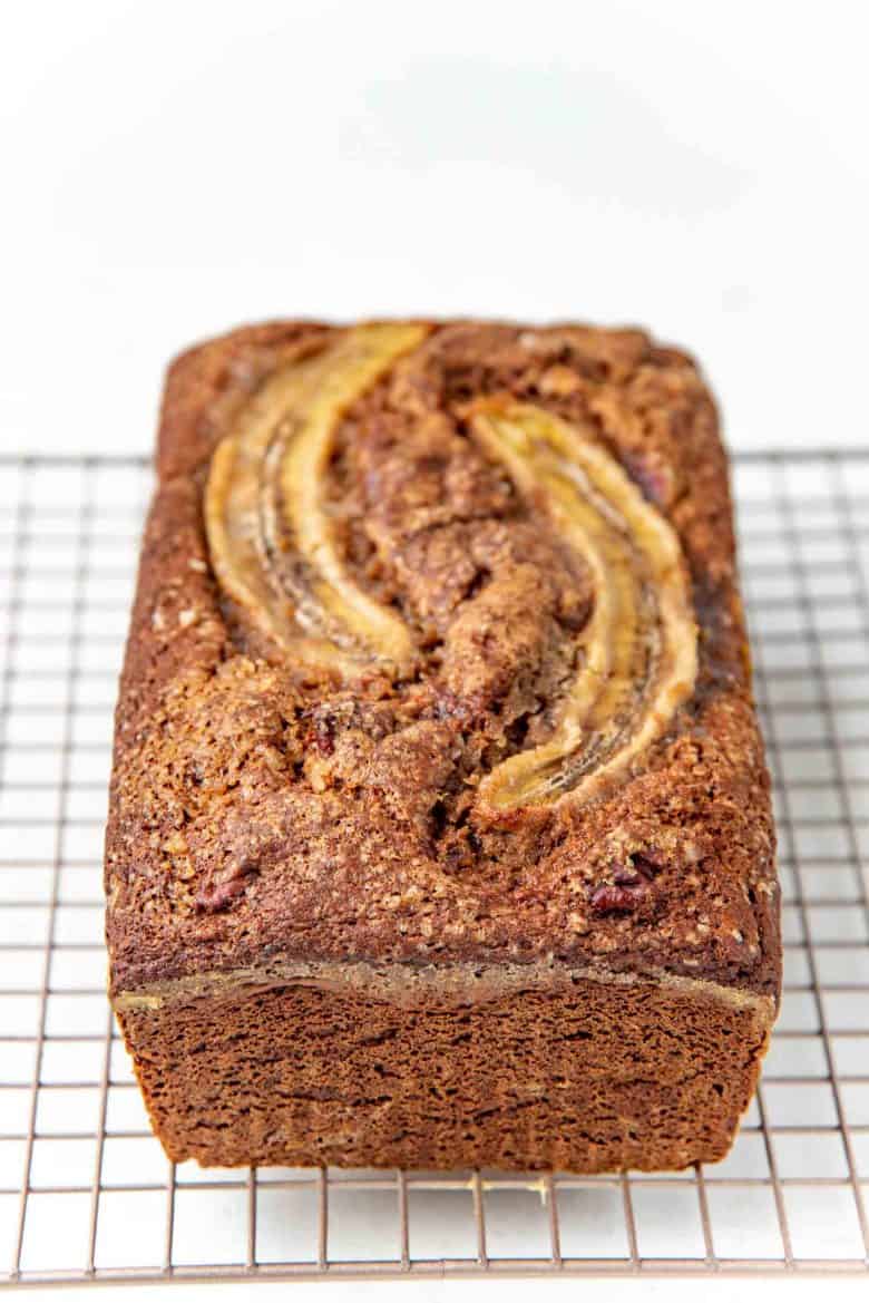 Whole wheat banana bread cooling on a wire rack