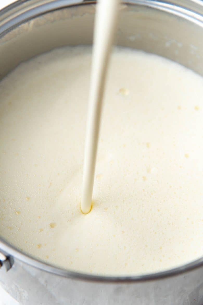 Pouring cream to the eggnog base