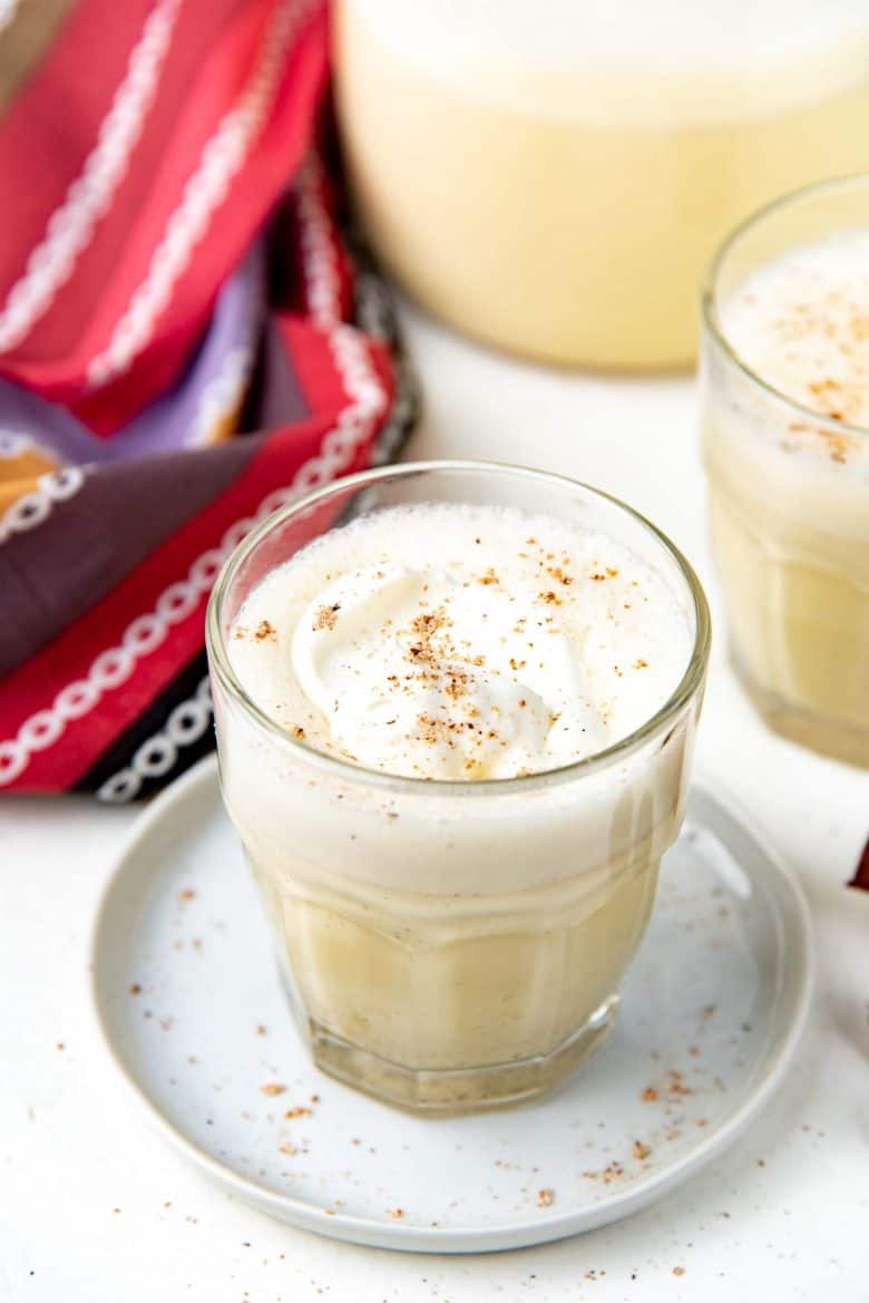 Close up of eggnog with whipped cream on top