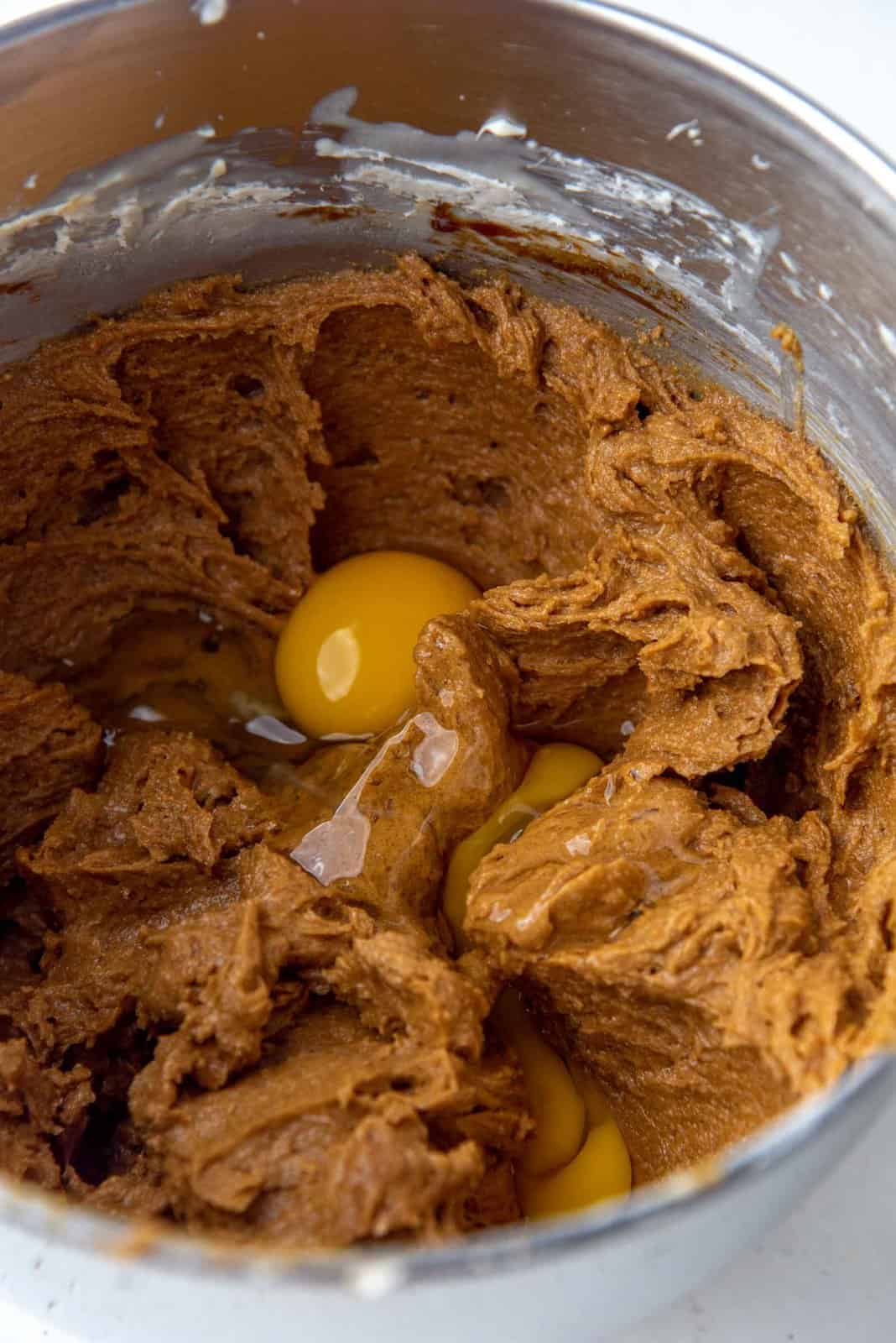 Adding eggs and vanilla to the ginger cookie dough