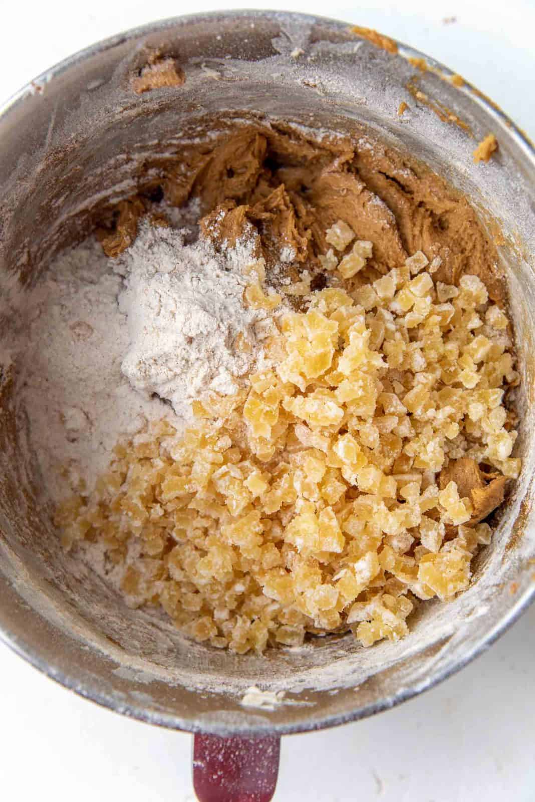 Final dry ingredients and chopped crystallized ginger added to the soft ginger cookie dough
