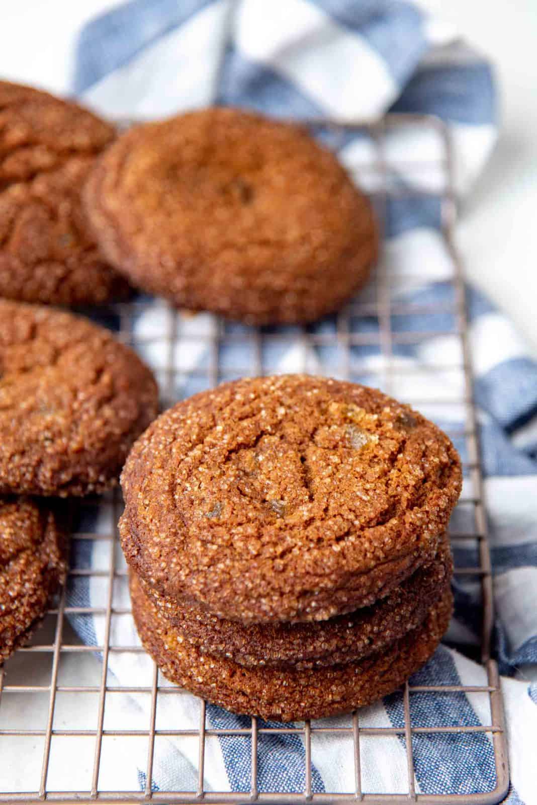 A stack of  chewy soft ginger cookies on a wire rack