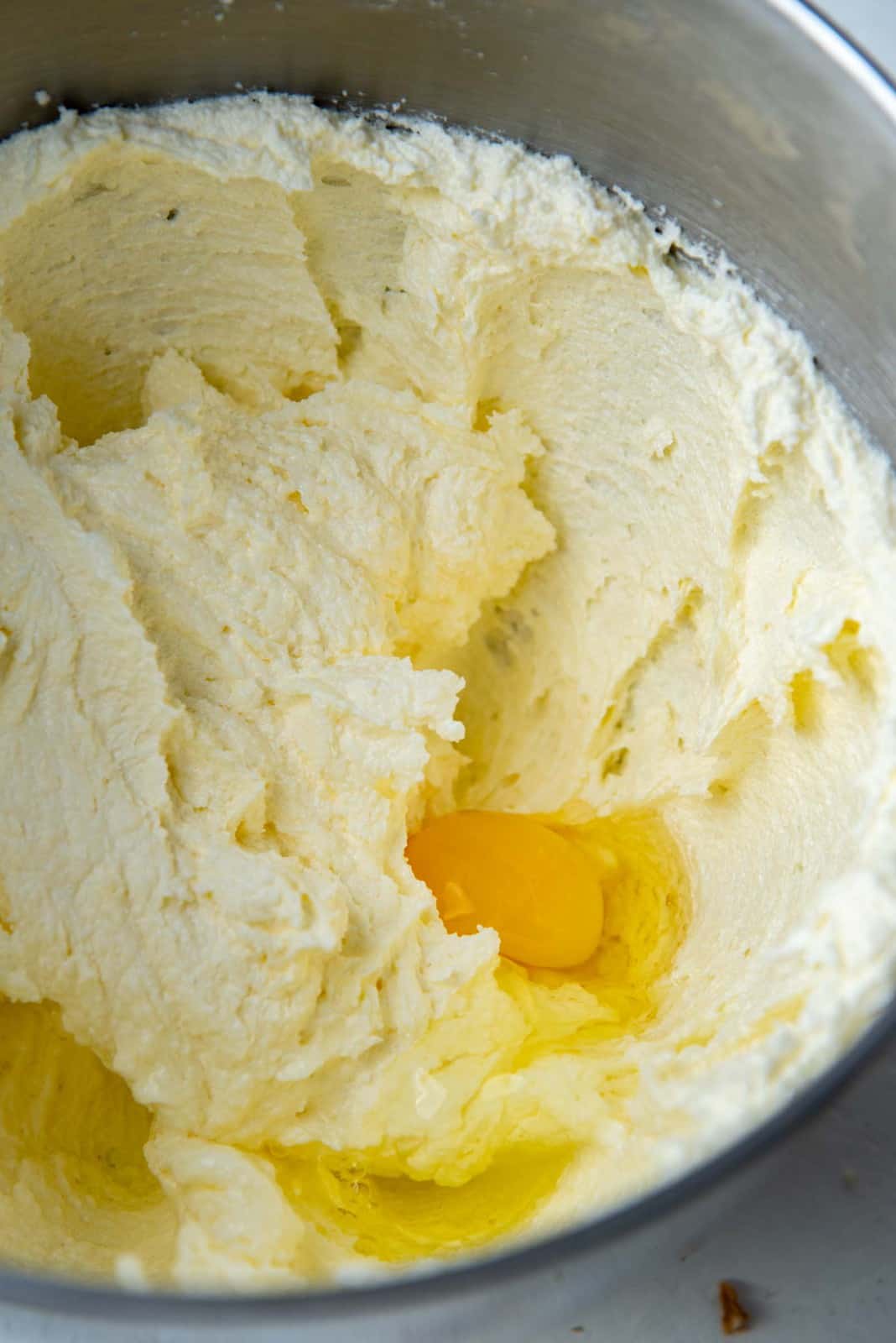 Adding eggs to creamed butter and sugar