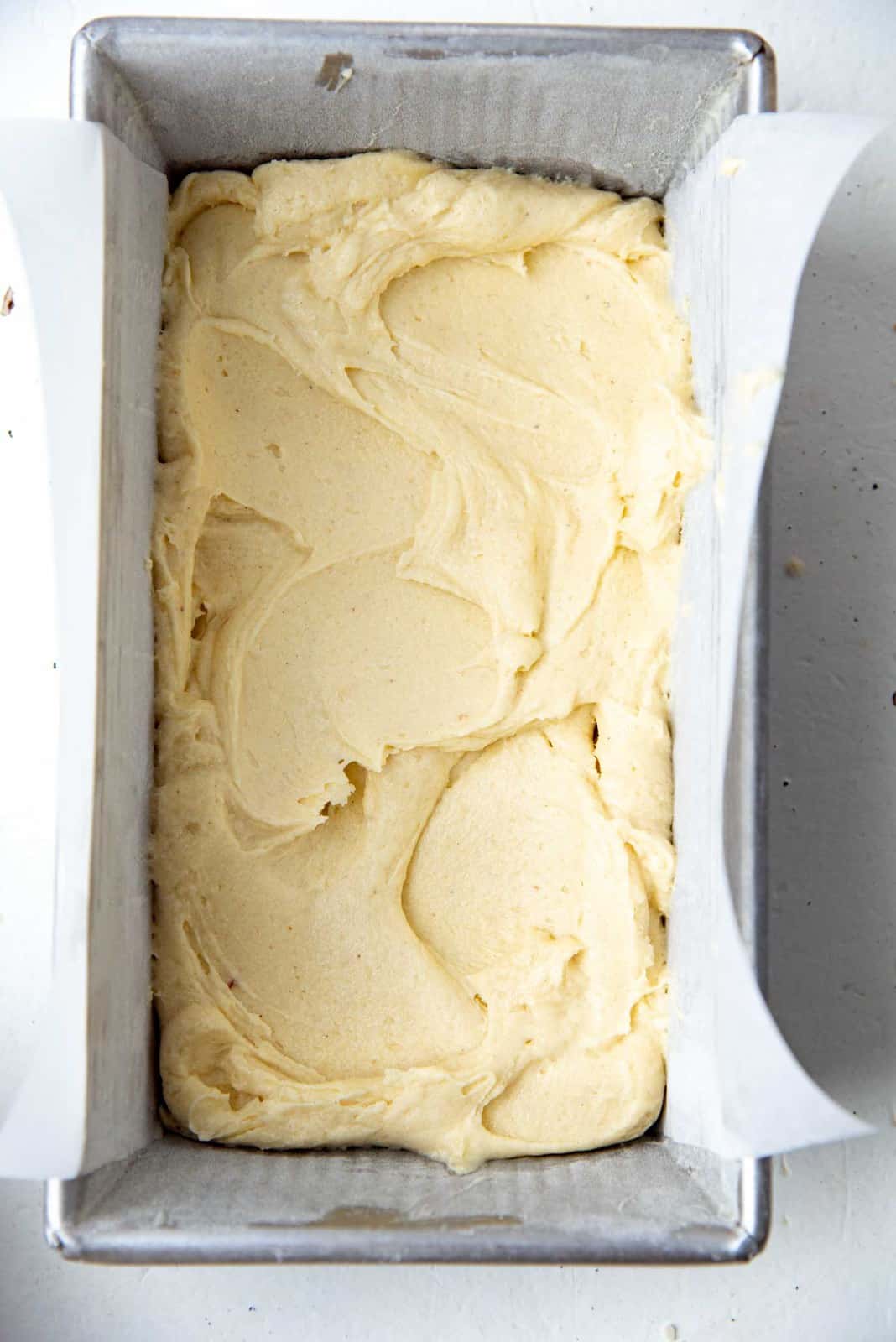 Layering half of the batter in the loaf pan, and spreading it out