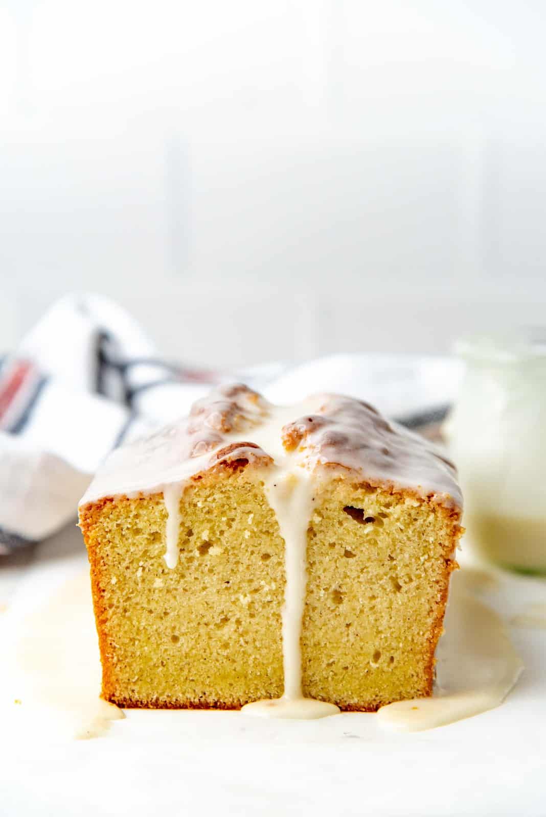 eggnog pound cake with eggnog glaze on a white surface