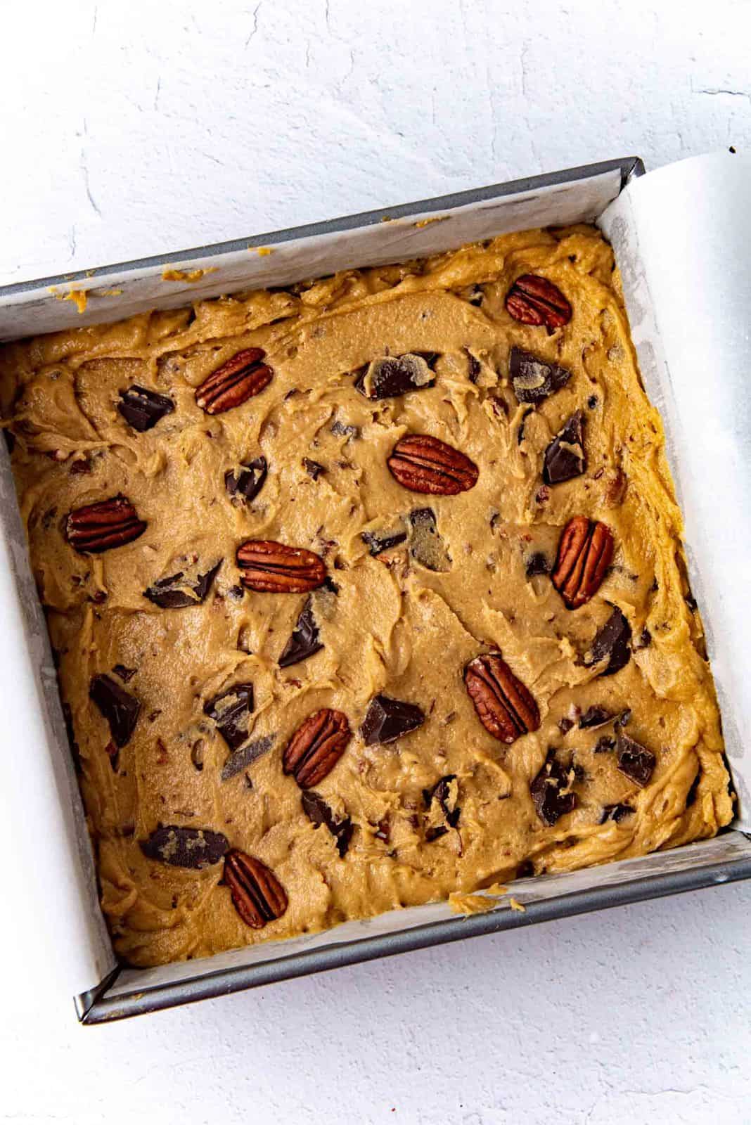 The blondie batter spread inside the prepared baking pan