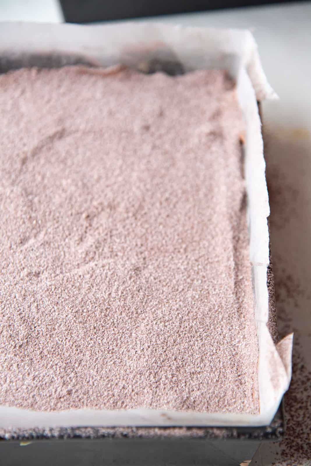 The mallow mix sifted over the surface of the chocolate marshmallow mix