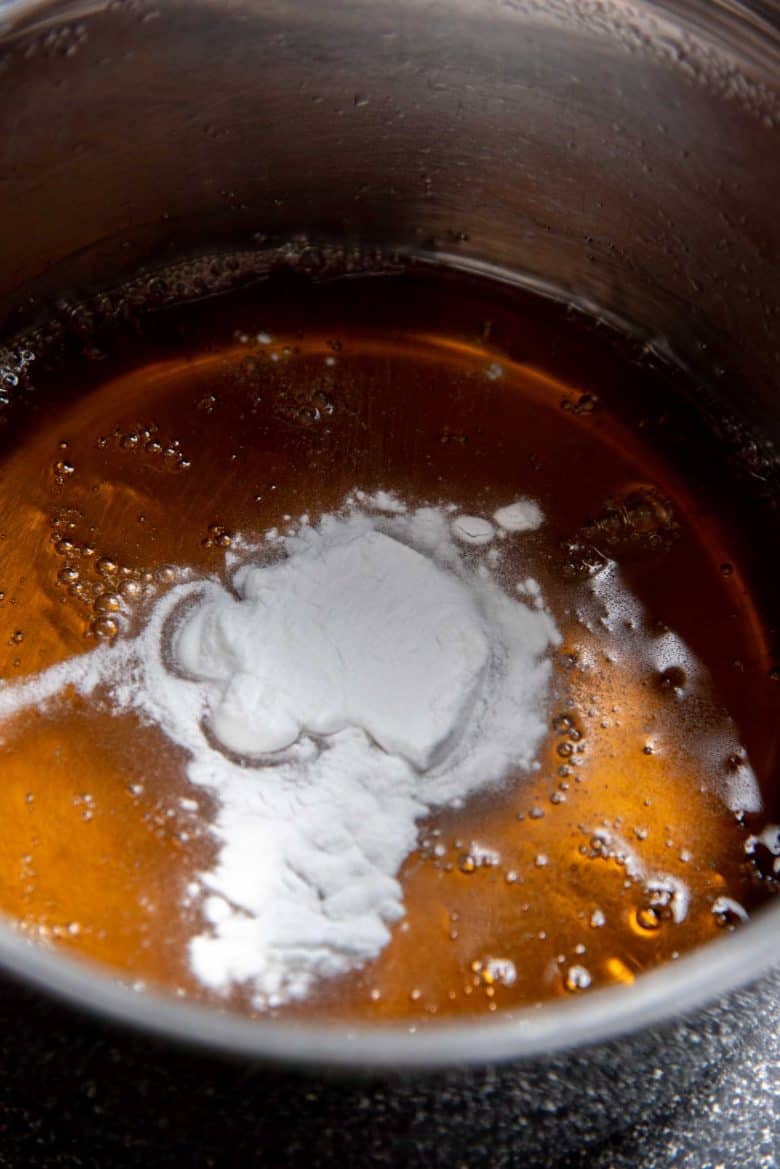 Adding baking soda to the hot sugar syrup