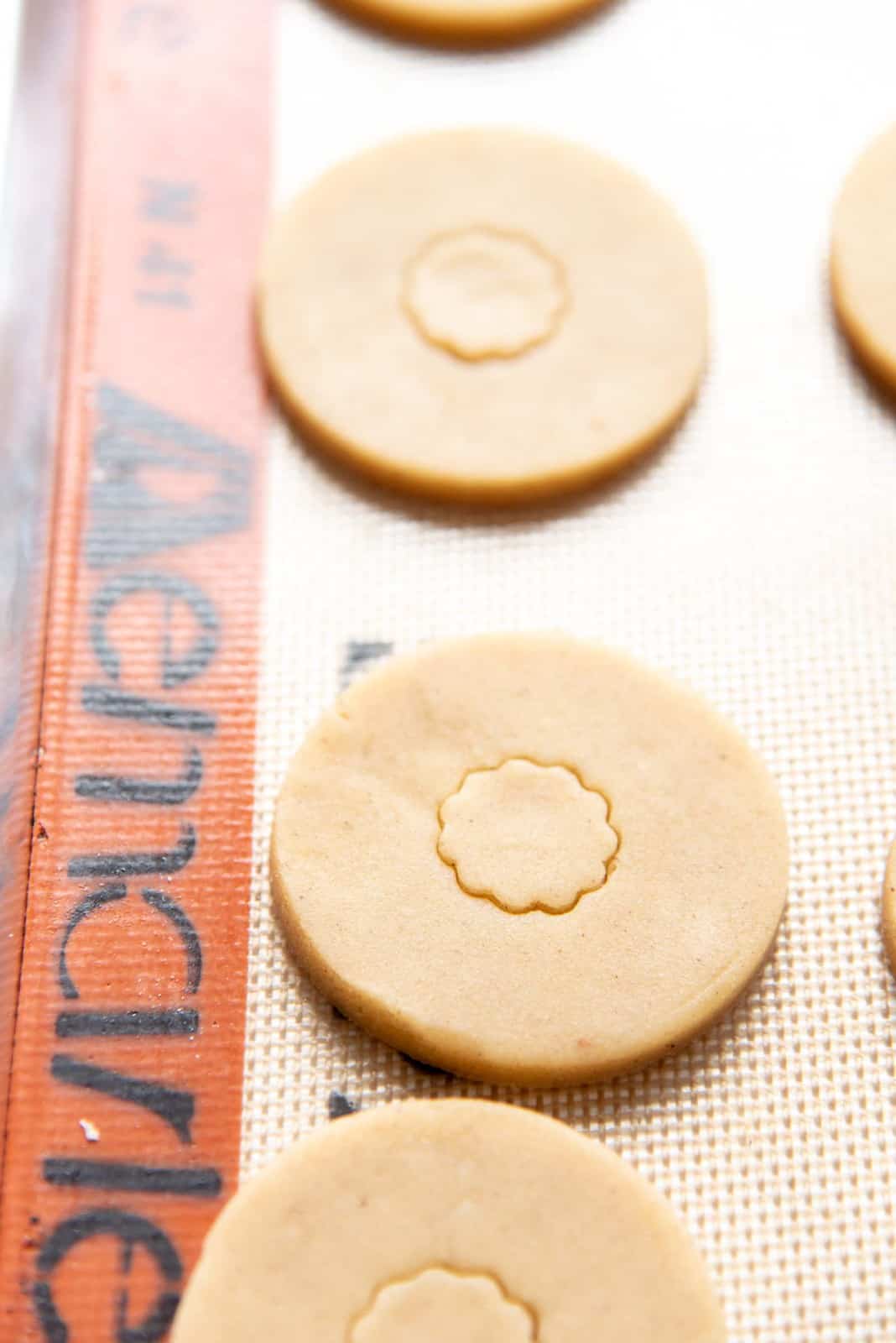 Cutting a hole in the center of half of the cookies