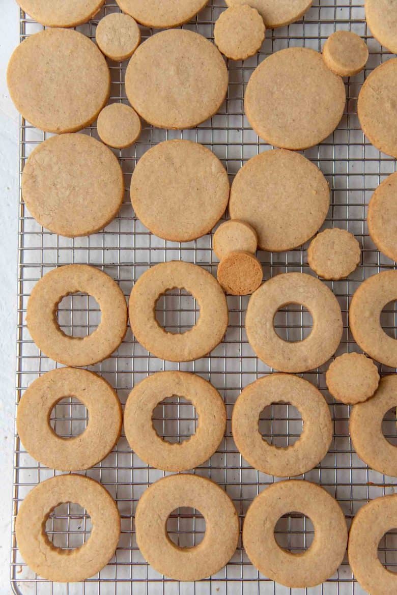 Freshly baked linzer cookies cooling on a wire rack