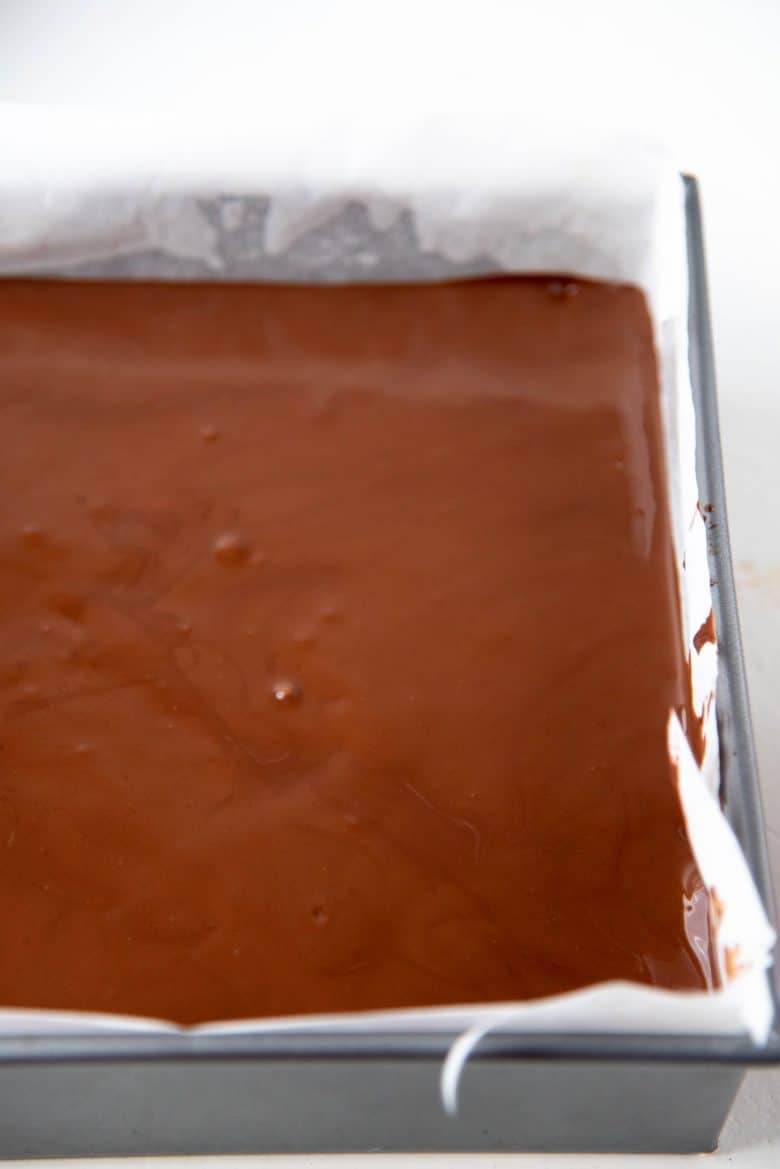 The chocolate layer spread evenly on the mars bar rice krispie layer