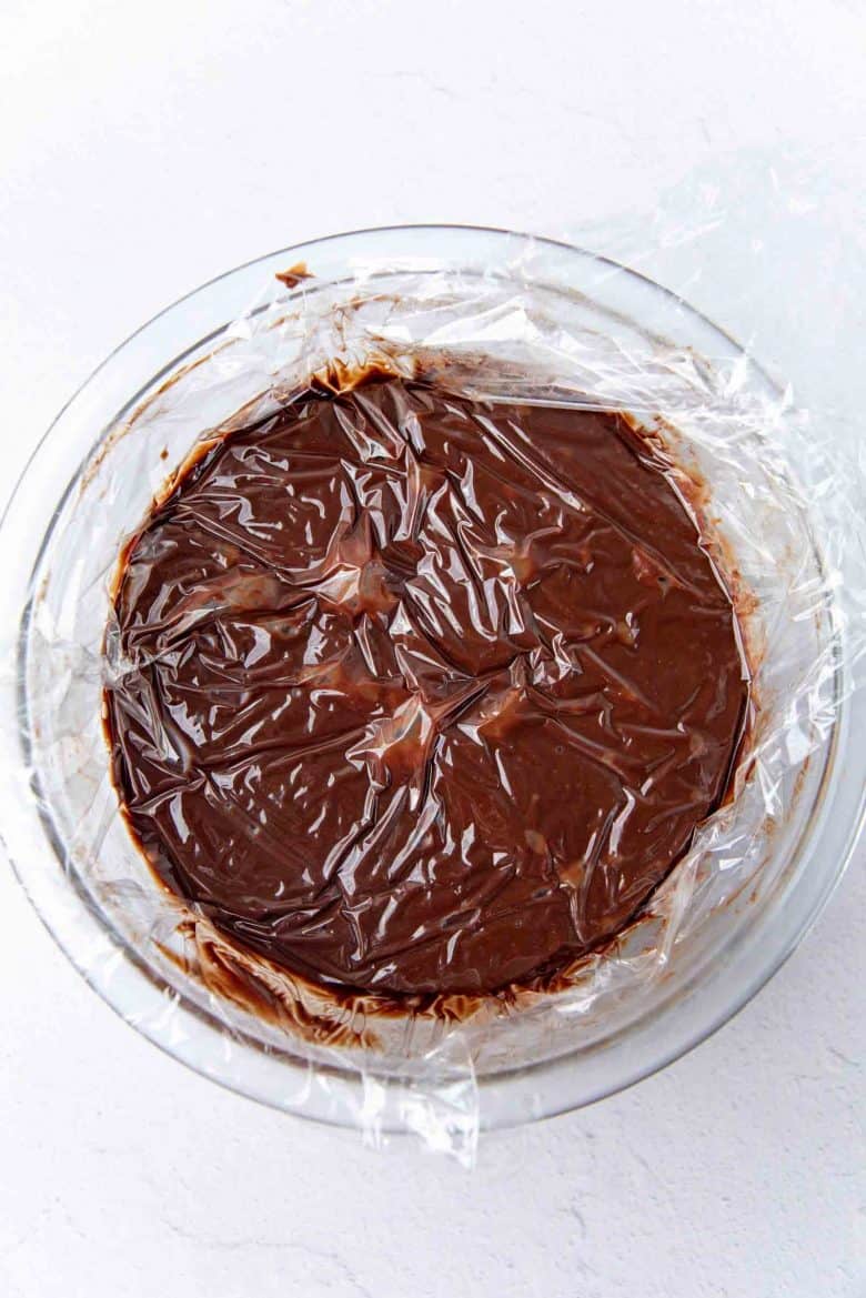 Ganache mixture covered with plastic wrap