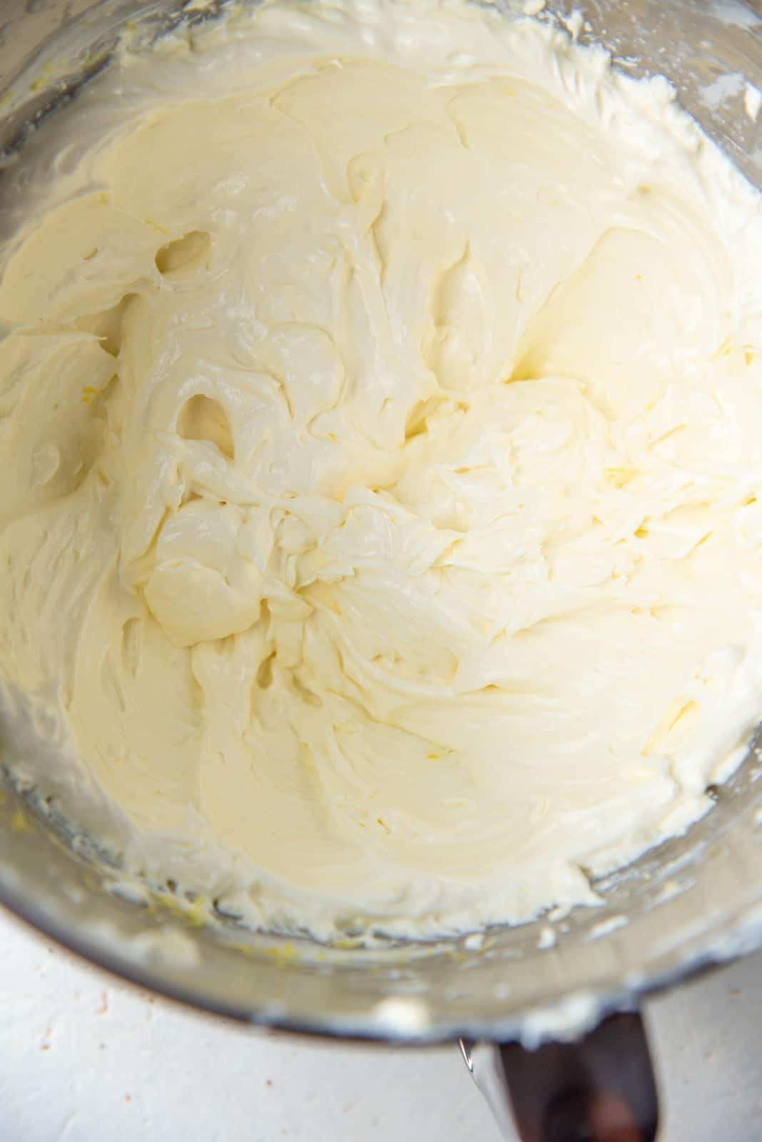 Fluffy cream cheese mixture in a mixer bowl.