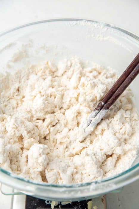Mixing hot water into the flour with chopsticks