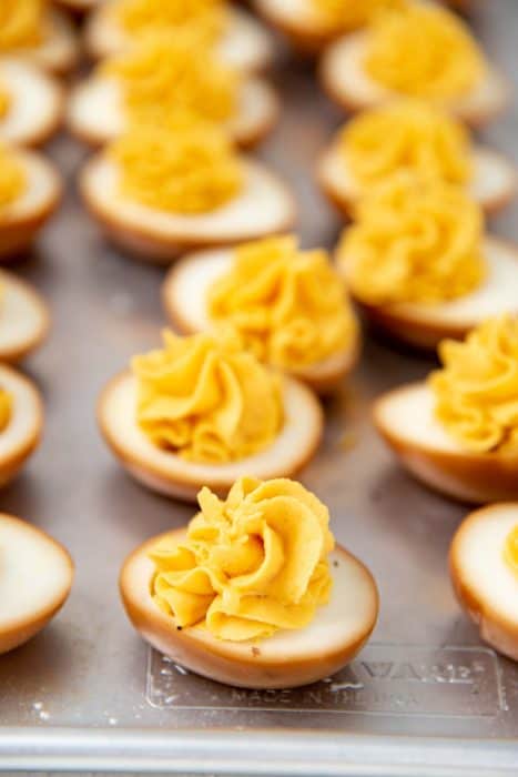 Asian deviled eggs, with the filling piped inside the marinated eggs
