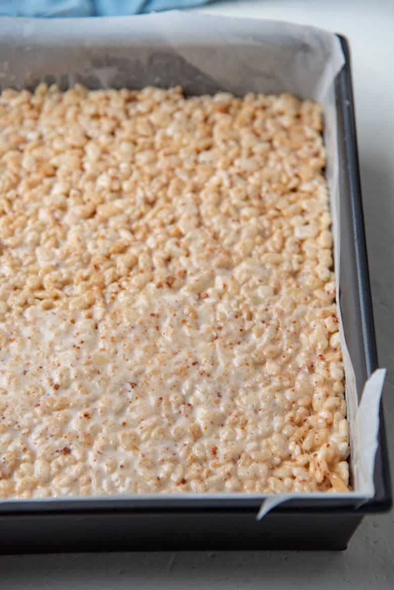The rice krispie treats base pressed into a pan