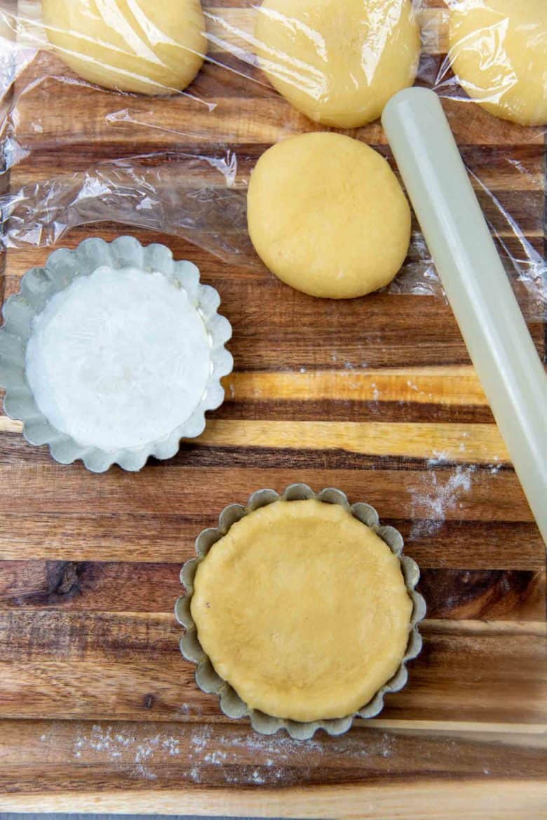 Placing the dough in prepped mini tart tins