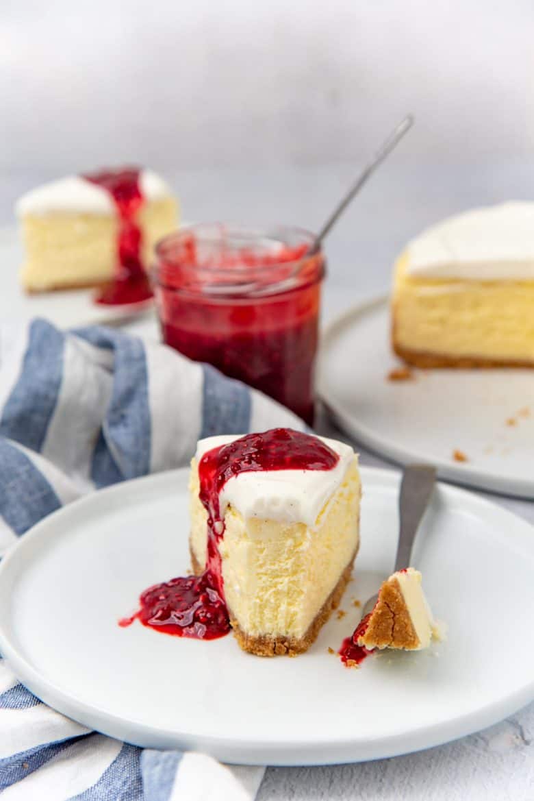 Cheesecake slice with a bite sliced from the edge