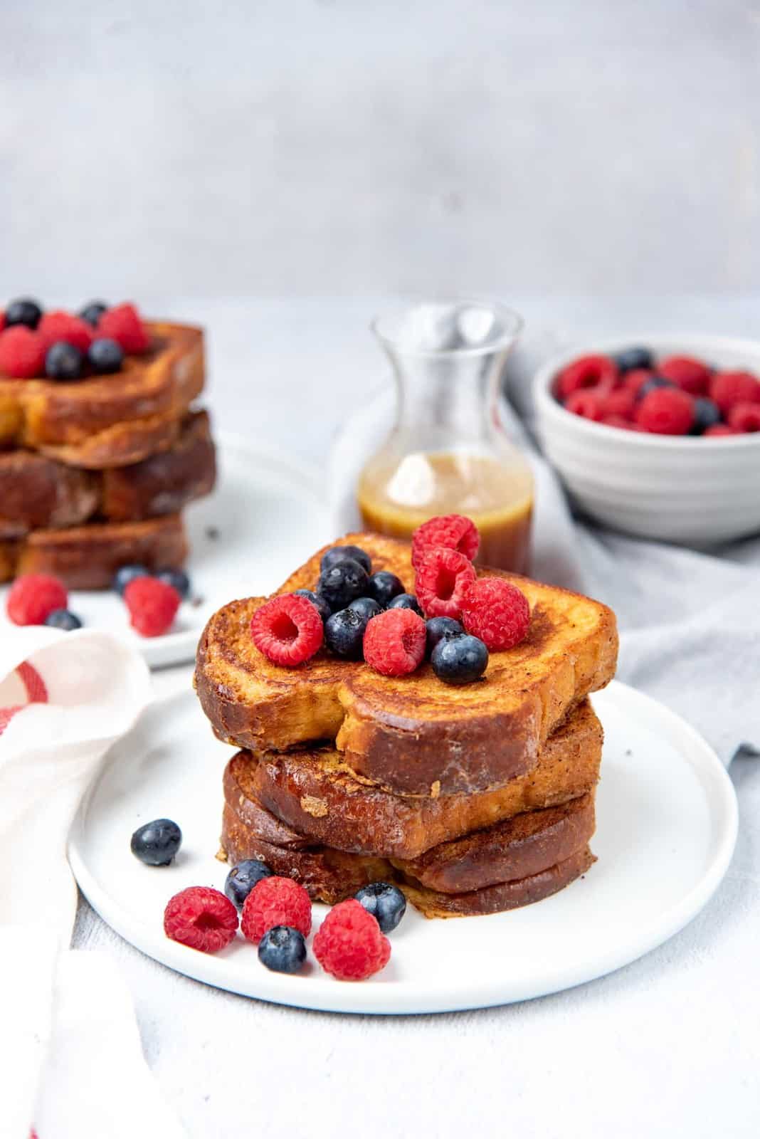 Stack of custard toast with berries on top