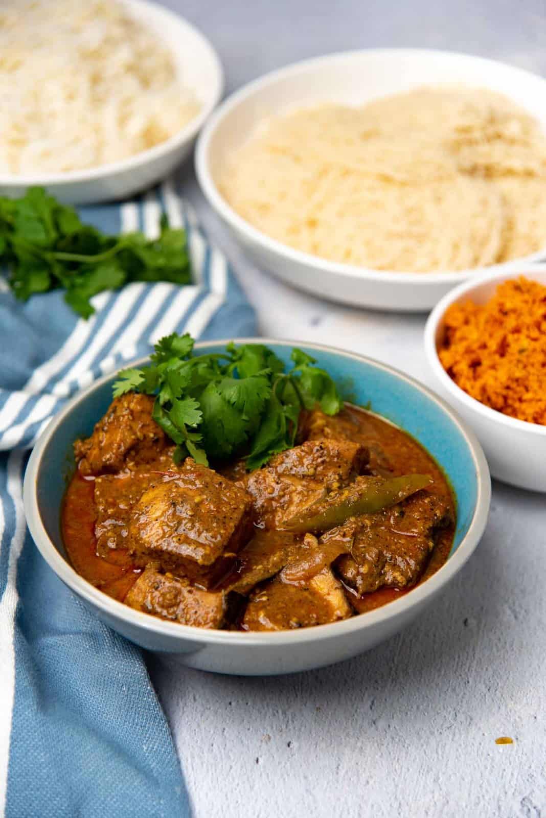 Spicy fish curry made with coconut milk served in a bowl