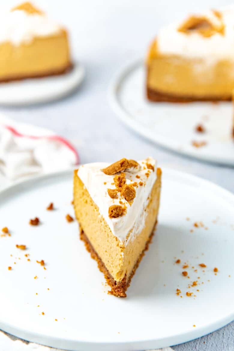 An angled view of the pumpkin cheesecake showing the whipped cream topping