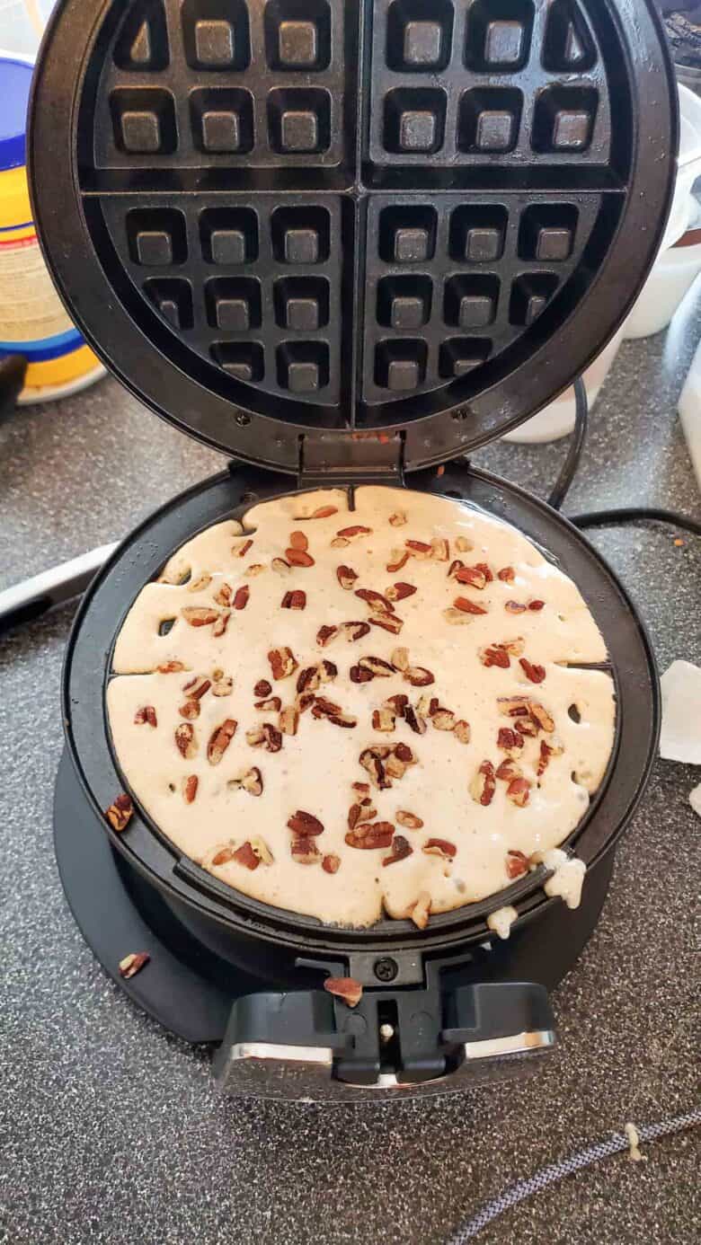 Yeasted waffle batter in the waffle maker with pecans