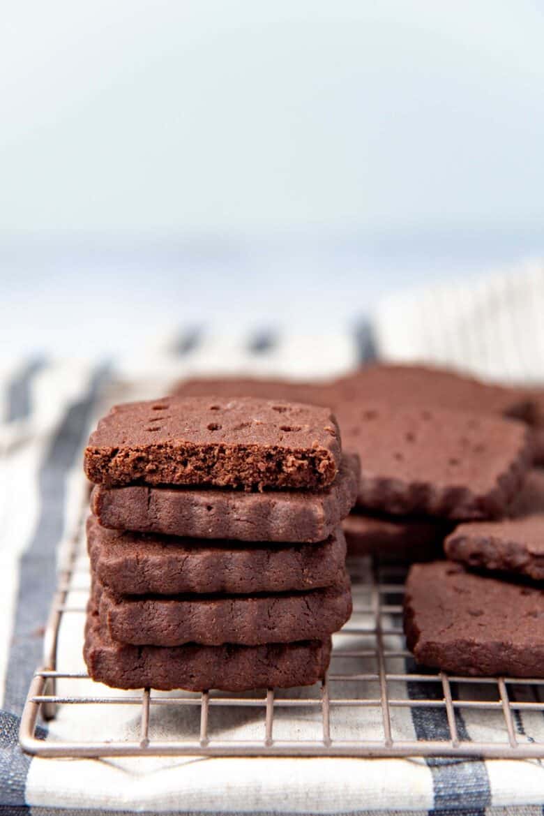 A stack of cookies, with the top one cut to show texture of cookies