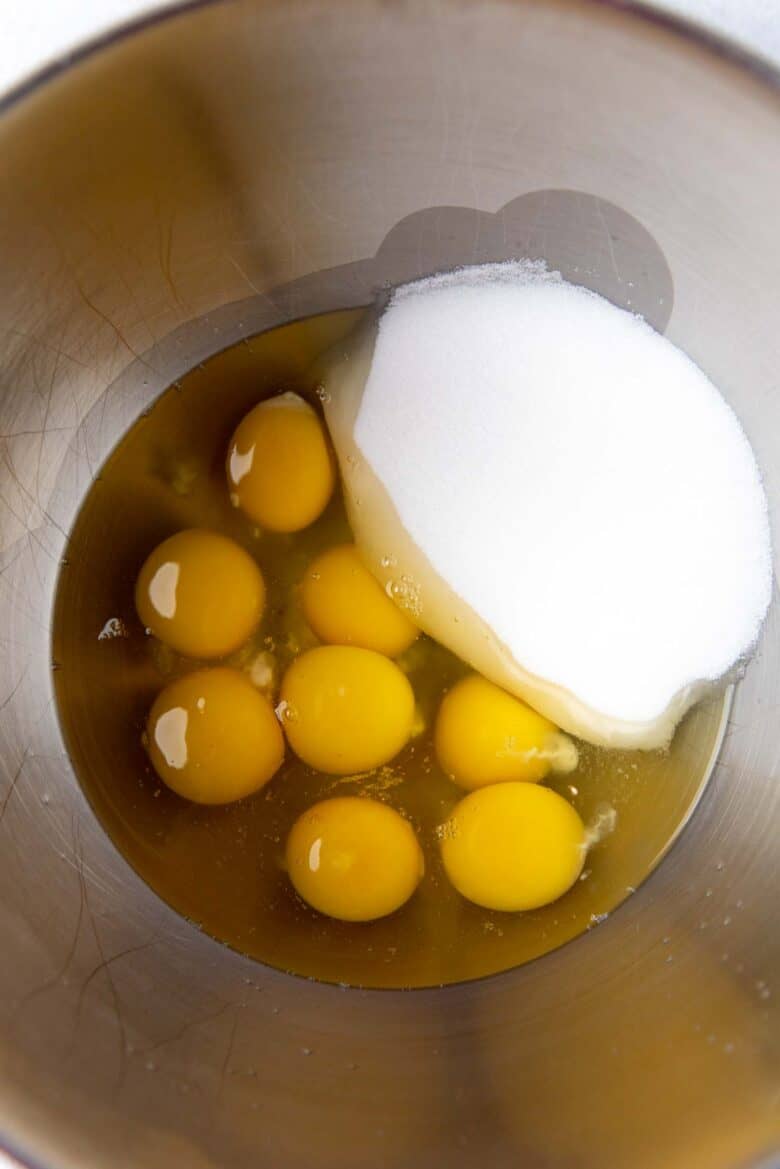 Whole eggs and sugar in a mixing bowl