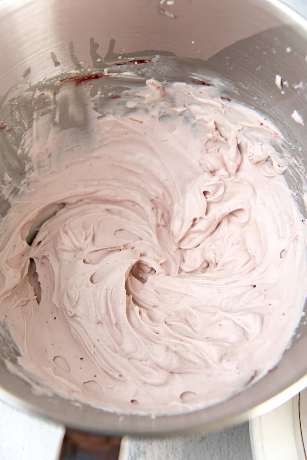 Whipped cream frosting in the bowl, showing the soft consistency